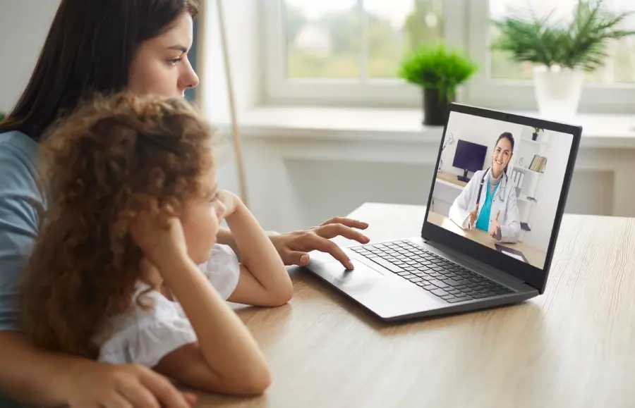 Mother and child speaking with a doctor